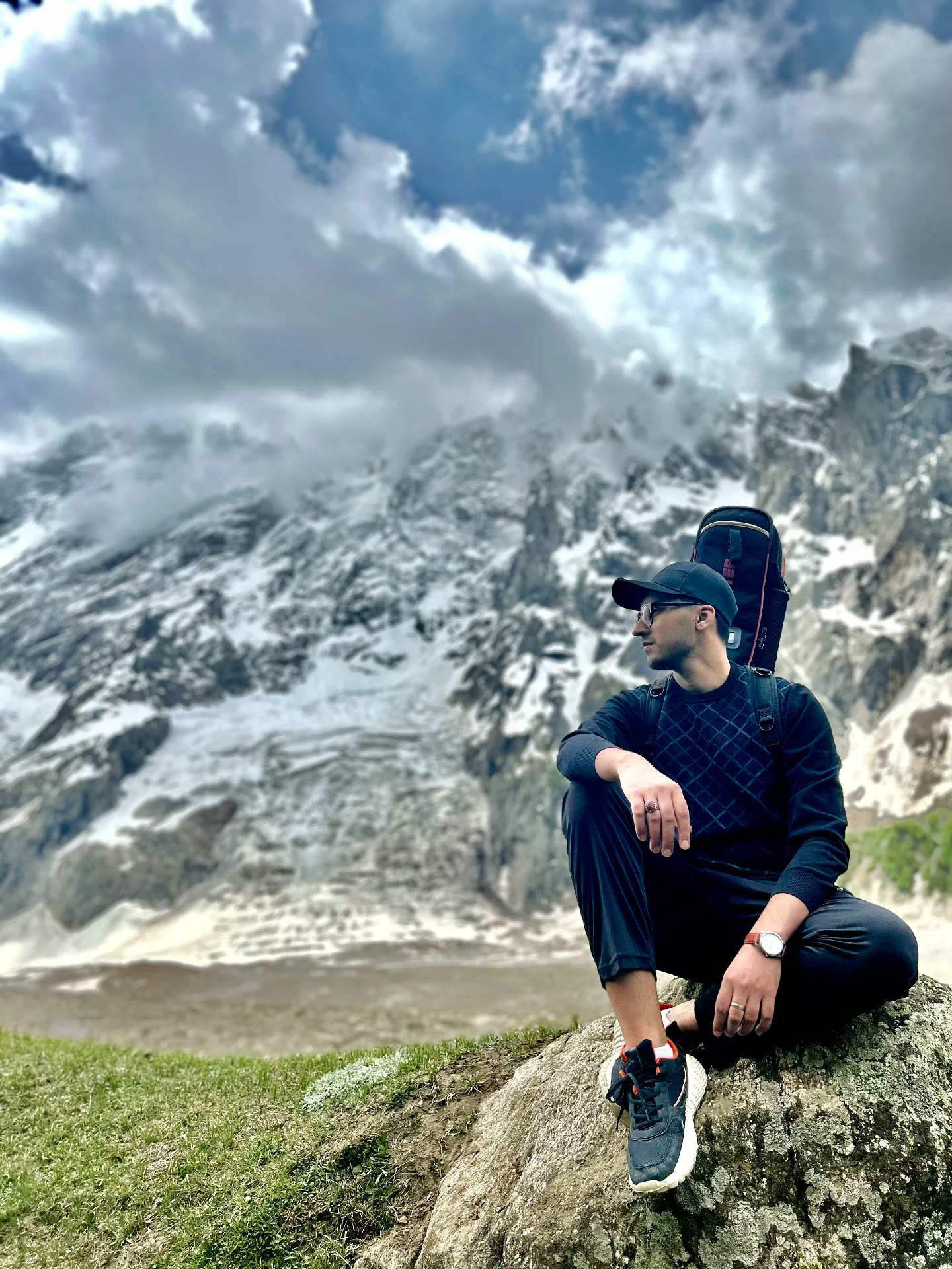 Syed Muhammad sitting on a rock in front of a glacier in northern Pakistan